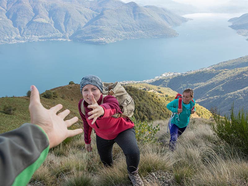 Hiker giving helping hand to teammate